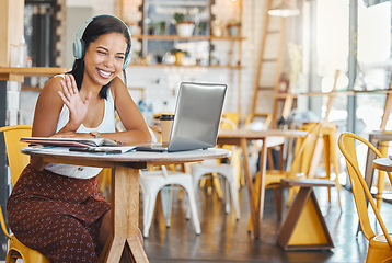 Image showing Webinar meeting at internet cafe with woman on laptop video call with headphones waving, greeting webcam in coffee shop. Business freelance worker with smile in zoom meeting for remote global company