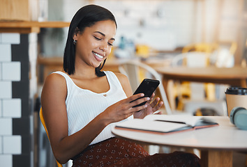 Image showing Texting a message or browsing social media on a phone by a young female student sitting in a coffee shop smiling. A relaxed woman relaxing and searching the internet or chatting online at a cafe
