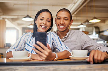 Image showing Happy couple on a video call on phone, bonding on a coffee date at a cafe or restaurant, taking a selfie. Young girlfriend and boyfriend browsing online, checking social media and relaxing together