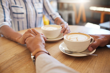 Image showing Coffee, break and dating couple holding hands on a romantic date at a cafe, restaurant or coffee shop. Man, woman or people touching, in love and romance on anniversary or valentines day together