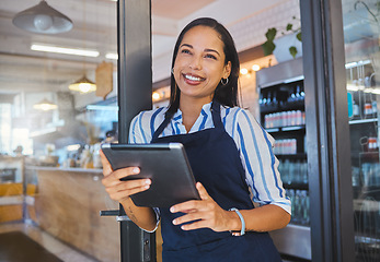 Image showing Startup, cafe and business woman in management with smile working on a digital tablet at the store. Manager, coffee shop owner or worker of a small business at work in retail with technology.