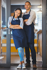 Image showing Small business owners standing at the entrance of their coffee shop, proud and ready for customer. Young power couple excited about their startup, feeling successful while waiting and opening cafe