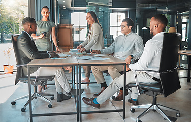 Image showing Business meeting in a boardroom of colleagues talking and planning company growth strategy together. Group or team of diverse and happy employees having a discussion in a modern office