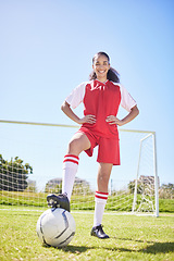 Image showing Sports, football and female athlete training at stadium grass sport field with goal post. Portrait of smiling, excited and happy woman soccer player getting ready for workout standing on green pitch