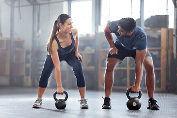Image showing Strong, wellness couple doing kettlebell weight exercise, workout or training inside a gym. Happy sports people or trainer motivation, exercising with fitness equipment for muscle, strength or health