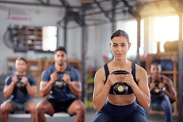 Image showing Kettlebell squats, fitness and training group of healthy people living an active health, wellness and body or weight watching lifestyle. A sports team doing a workout or exercise in a gym class