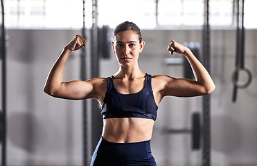 Image showing Gym, fitness and woman flexing muscles with energy to show off her biceps and strong abs in a sports studio. Training, exercise and workout motivation of a healthy, body and muscular in a portrait