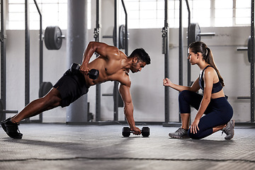 Image showing Muscular, sports man with female gym instructor or fitness coach doing body building workout, push up plank exercise. Active male athlete weightlifting in wellness center with trainer for motivation.