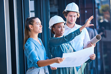 Image showing Building construction management team with an architect and engineering blueprint. Teamwork development collaboration of industrial engineer group planning a architecture renovation project