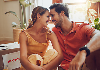 Image showing Happy and in love couple sitting together, bonding and spending quality time in a new apartment, flat or house. Homeowner, loving man and woman relax, care free and enjoy a day inside with a smile