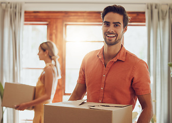 Image showing Happy couple moving into new home, people carrying boxes to property and relocating to apartment together. Portrait of smiling, cheerful and handsome man packing for move with woman standing at house