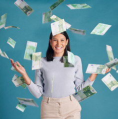 Image showing Wealthy, rich and money rain or falling from the sky for financial success and growth. Portrait of a successful, happy and excited female catching cash and enjoying finance investment or lottery win