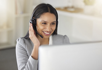 Image showing .Call center agent or CRM business woman talking on phone with headset and computer offering client support and help. Contact us for telemarketing worker or customer service support consultant.