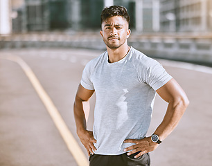 Image showing Fitness, sports and runner with motivation, wellness goals and vision in city, town or dowtown. Portrait of active, athletic or healthy man on street for routine running workout, exercise or training