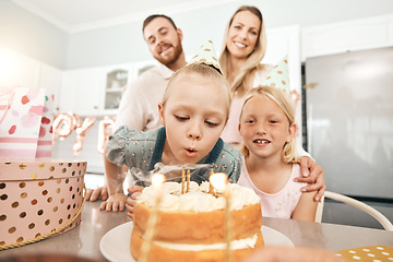 Image showing Children birthday party, cake and candles for blowing out with mother, father or sister in home kitchen. Fun, excited or happy kids celebrating, enjoying and having fun with parents on special event