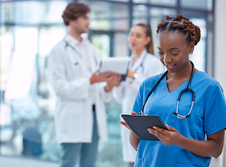 Image showing Female nurse or doctor browsing on a tablet for patient diagnosis or treatment on a medical or mobile healthcare app in a hospital. Professional gp or surgeon wearing scrubs while working in a clinic