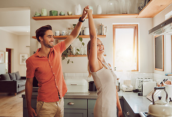 Image showing Happy, dancing and loving couple bonding and having fun while spending time together at home. Energetic, fun and active couple sharing a dance and romantic moment while enjoying their anniversary