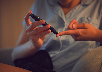 Image showing Diabetic, Diabetes or chronic disease by a woman testing blood sugar or glucose levels at home using a lancet pen. Closeup of a female piercing her finger to control her health condition