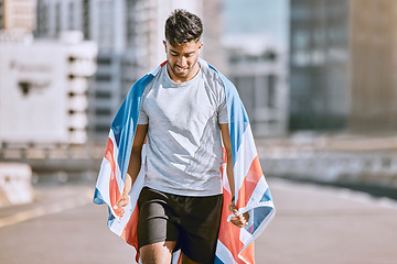 Image showing Fitness, training and workout with a sports man in a british flag running a marathon in the city. Health, exercise and wellness with an olympic athlete or runner exercising for cardio and endurance