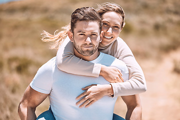 Image showing Playful and playing piggyback couple smiling, bonding and enjoying outdoors in summer or spring. In love, dating and in relationship partners playing and having fun on a romantic date together.