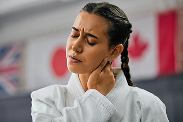 Image showing Woman karate student with bad neck pain at fitness training studio, person holding head from sport injury at health gym and muscle cramp from learning self defense at school. Painful joint accident