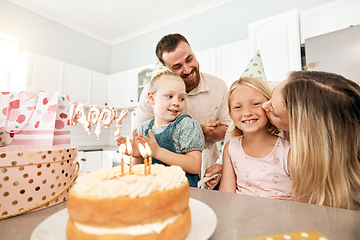 Image showing Family birthday party, smile in home kitchen, happy mother kiss girl child, children love fun quality time together and bond over bake cake and food. Kid look at the camera of happiness in house.