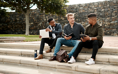 Image showing Startup entrepreneur team or friends planning business strategy with a laptop and digital tablet outdoors. Diverse, young and creative men in collaboration, sitting and discussing project together.