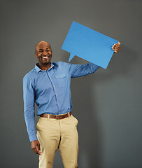 Image showing Smiling, african american male voter holding a copyspace board sign on public opinion message. Casual and positive man holding a social media speech bubble or communication icon for news poll idea