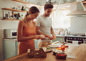 Image showing Cooking food, happy and healthy couple preparing a dinner meal in the kitchen together at home. Excited, carefree and joyful lovers doing smiling and laughing while making food or lunch