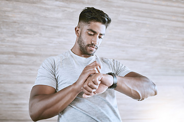 Image showing Man with digital smartwatch for health, fitness and performance progress tracking after exercise or training. Strong and healthy young man or athlete check with tracker watch for time and heart pulse