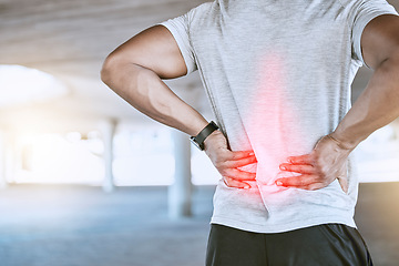 Image showing Sports man with back pain or injury after a fitness workout or exercise training outdoor. Runner with hurt muscle after cardio fitness routine with red graphic highlight on the body or injured joint