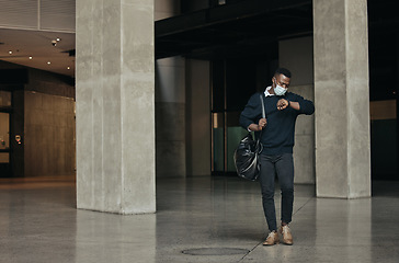 Image showing Covid, travel restrictions and time with a business man looking at his watch and late in an airport. Leaving the office or a hotel in hurry or rushing after working overtime on a corporate deadline