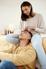 Image showing Romantic, in love and relaxed couple relaxing together in a lovely, cute and peaceful home romance indoors. Loving, carefree and calm girlfriend smiling and stroking her young boyfriends hair