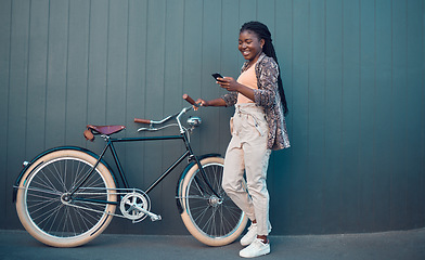 Image showing Girl, relax with bicycle and using smartphone app, social media and doing a internet or web search. Student uses her bike for health, fun workout or travel by cycling to school, university or college