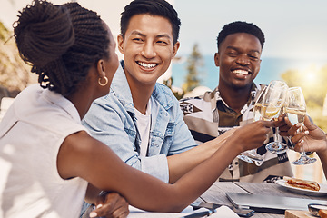 Image showing Diverse group toasting and celebrating friendship at an outdoor restaurant, having fun and laughing. Happy people cheers while bonding, talking and enjoying a celebration of good, exciting news