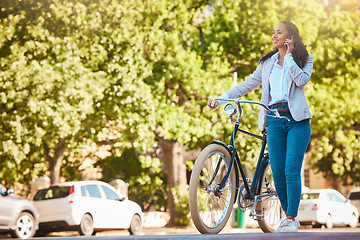 Image showing Bike, phone and walking with a young woman talking, exploring and sightseeing the city while enjoying travel and tourism. Carbon footprint, going green and eco friendly lifestyle with a happy female