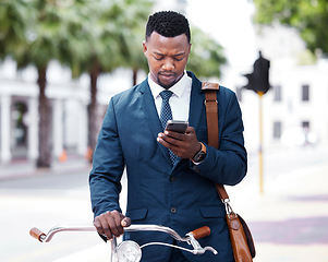 Image showing Reading, texting or web search on a phone of a business man ready to ride a bike to work or home. Digital entrepreneur using 5g internet on modern technology before riding a bicycle in the city