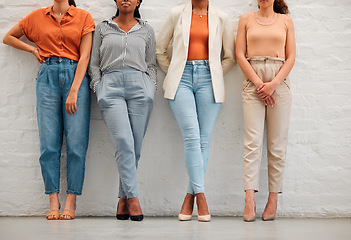 Image showing Creative and stylish team of business women against wall together, doing teamwork and collaboration at work. Shoes and legs of professional and corporate employees and workers working at a startup