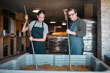 Image showing Production, manufacturing worker and teamwork in wine industry and labor press tool for fermentation of grape fruit alcohol. Sommelier people working in winery, distillery or warehouse at a vineyard