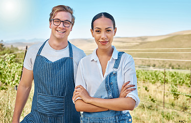 Image showing Couple farming on a wine farm in summer, farmer gardening on a vineyard or field and smile with green sustainable lifestyle. Portrait of interracial man and woman with arms crossed for agriculture