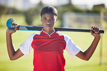 Image showing Hockey player or coach holding stick ready for a competition or match on the sports ground or field. Portrait of a serious, fit and active black woman athlete at fitness training, exercise or workout