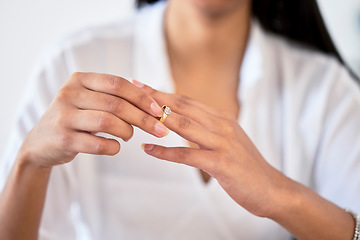 Image showing .Woman hand taking off ring or jewelry for divorce and break engagement after fail marriage. Depressed, frustrated or widow sad with regret, upset or worried over cheating or affair in relationship.