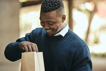 Image showing Food, delivery and happy business man on a lunch break outside, smiling while opening a brown paper bag. Hungry worker satisfied with meal order, ready to enjoy a snack. Male impressed by deliver app