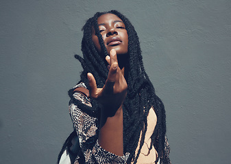 Image showing Beauty, culture and heritage with a black woman in studio against a gray background. Portrait of a beautiful african american female with braided hair posing and feeling confident with attitude