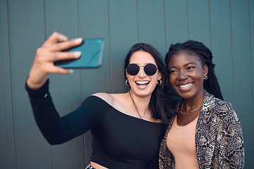 Image showing Happy girl friends taking a selfie on phone while traveling around the city on summer vacation. Diversity, love and smiling women taking picture on smartphone to post on social media and the internet
