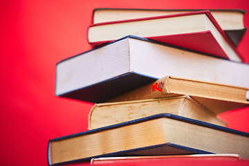 Image showing Books, education and learning for school or academic research isolated on a red studio background. Studying, reading and a library book for scholarship research to gain knowledge