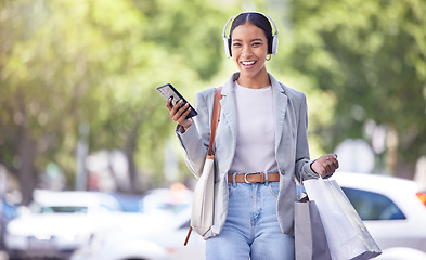 Image showing Shopping in city, woman with smartphone and headphones listening to fashion clothes podcast with smile on face for marketing sale tips and style idea. Retail customer with an audio streaming service