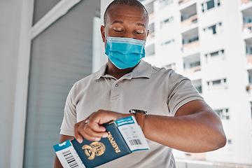 Image showing Covid, immigration and passport man with face mask for corona virus and travel restrictions or airport delay. Black man checking time and late due document problem, covid 19 compliance and regulation