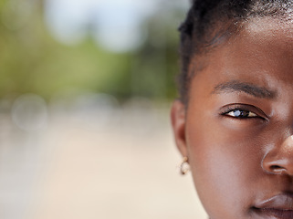 Image showing Serious face portrait of a woman with clear skin outdoors in natural light and background. African, female eye and head zoom focus isolated in nature with a confident and vision empowerment look