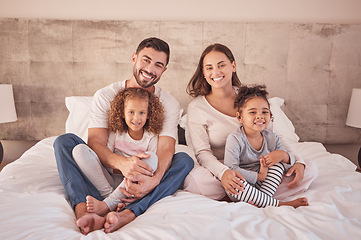 Image showing Family portrait on bed and happy mother, father and children wake up in the morning together with happy smile on face in their bedroom home. Happiness of mom and dad with kids while they relax